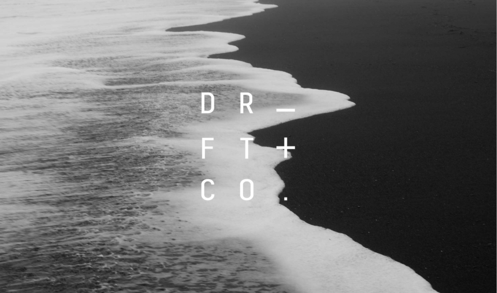 Logo of Drift and Co over top down image of beach and sea