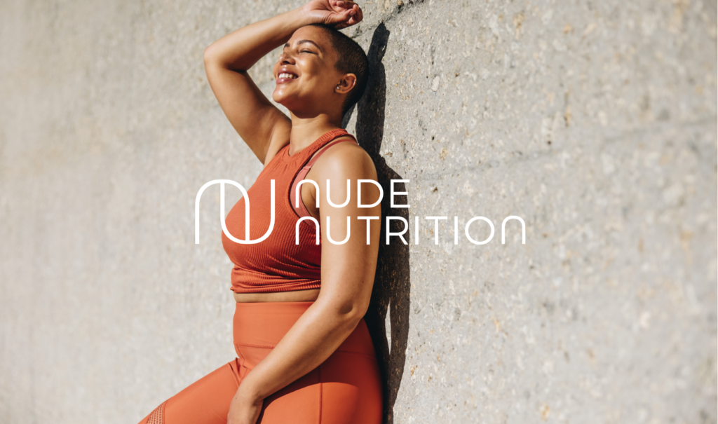 Logo of Nude Nutrition over image of woman leaning against wall smiling