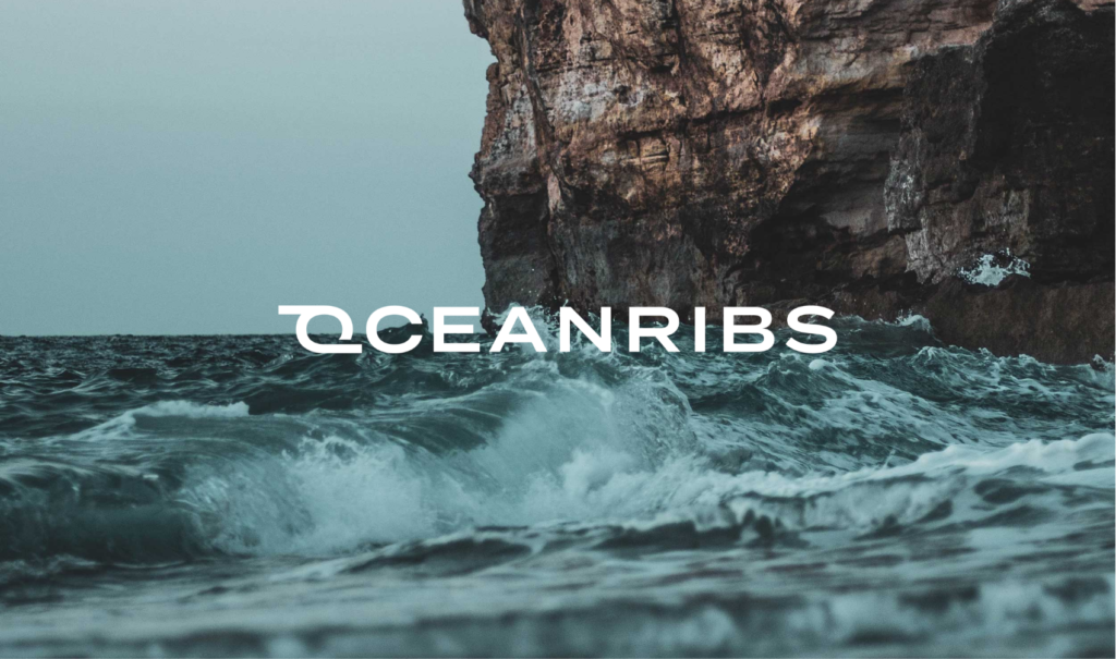 Logo of Ocean Ribs over image of water and rocks