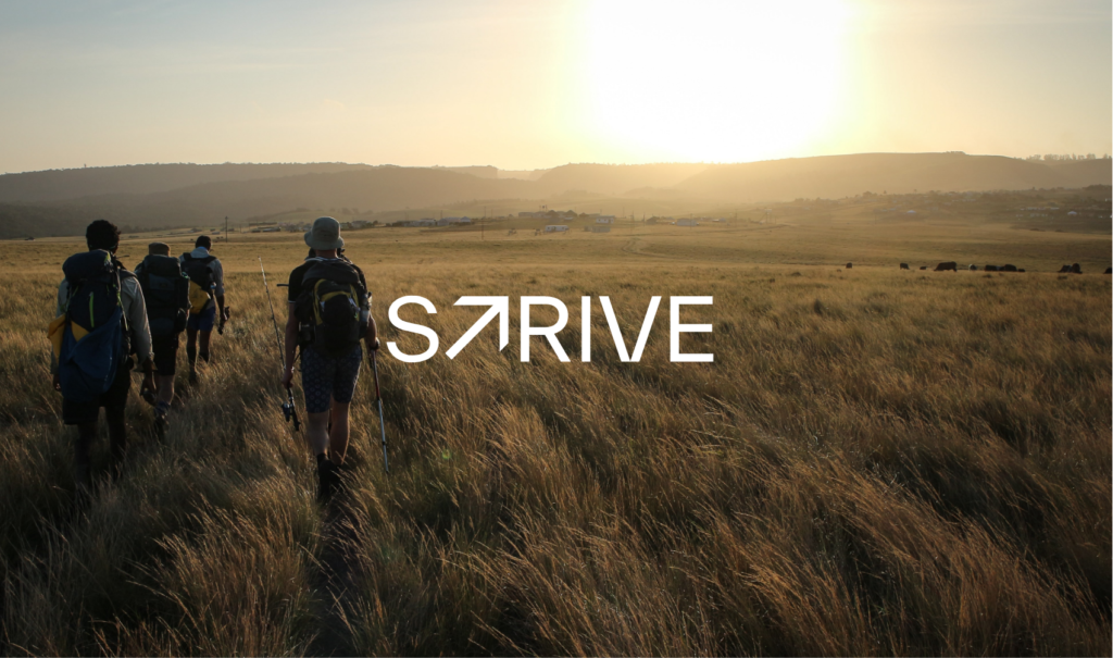 Strive logo over image of hikers walking into sunset